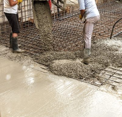 Pouring concrete into the construction of the house. Builders are pouring ready-mixed concrete