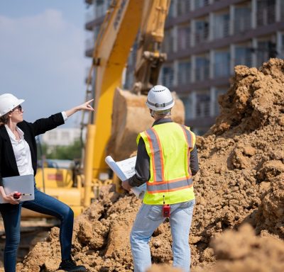 construction manager and engineer working on a demolition site